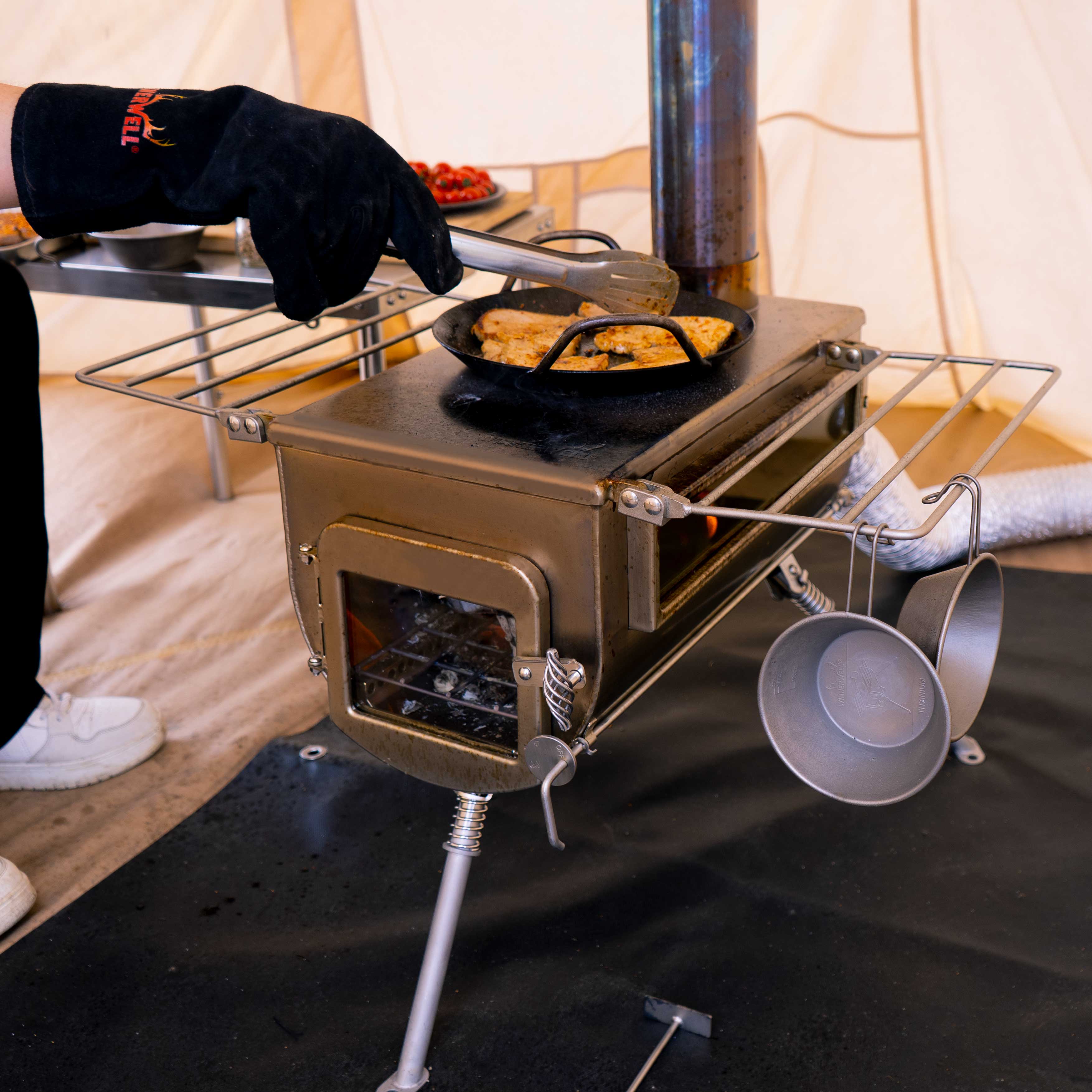 Close-up of Winnerwell® Woodlander PLUS Double View windows, displaying fire visibility through heat-resistant glass for safe wood-burning monitoring in tent stoves.