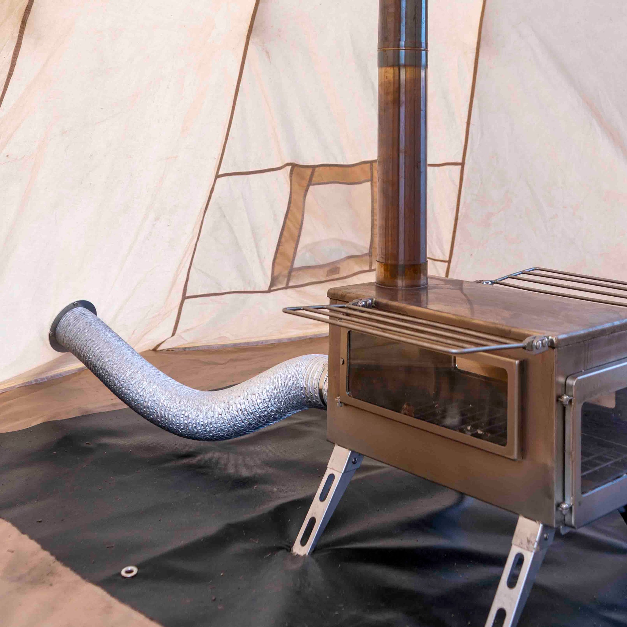 Winnerwell® M - sized Opener & Seal Set integrated with an M - sized stove and tent setup, highlighting its role in creating a proper seal for efficient and safe stove operation during camping.